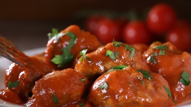  Eating Meatballs With Tomato Sauce From The White Plate