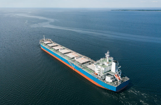 Aerial view of cargo ship floating in the sea