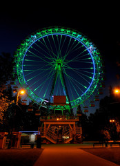 Amusement park at night - big ferris wheel with illumination