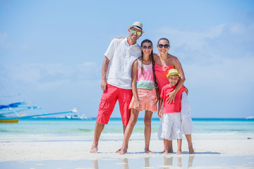 Family of four having fun at the beach