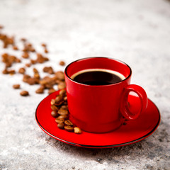 Coffee Beans Fragrant in the Red Cup on the Gray Background.