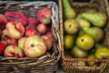 Nectarines and pears in wicker basket