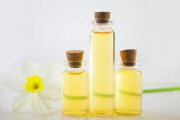 Essence of flowers  on white in beautiful glass jar