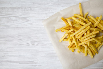 From above, tasty french fries. Closeup. Copy space.