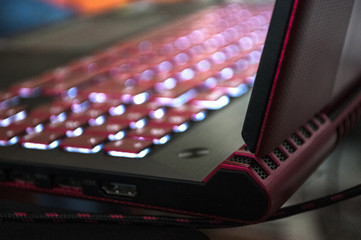A red-black gaming laptop with a luminous keyboard