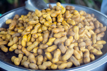 Over steam roasted peanuts on a street market