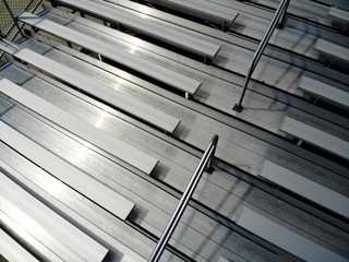Aerial drone shot of metal bleachers at a sports stadium