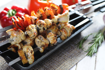 Kebab cooked on metal skewers with vegetables