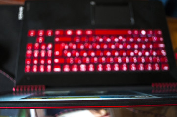 A red-black gaming laptop with a luminous keyboard