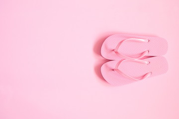 Pink beach flip flop on pink background. Summer concept. Flat lay, top view, copy space