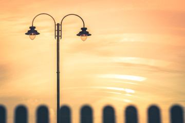 Street lamp during orange sunset