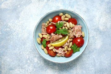 Tuna salad with cherry tomatoes and white bean.Top view with copy space.