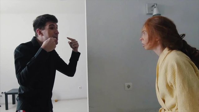 Girl and guy swear. Young guy fighting his girlfriend. Young couple arguing, fighting