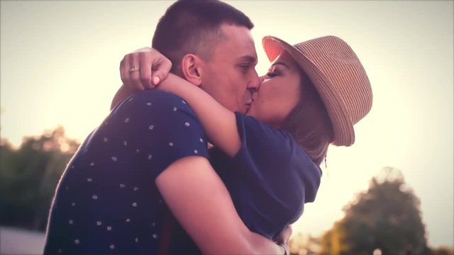 Beautiful Young Couple in Love kiss in the sun.
