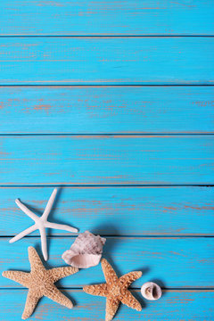 Summer beach seashore background starfish blue old wood vertical