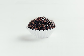 Brigadeiro is a typical homemade chocolate truffle from Brazil. Cocoa, condensed milk and sprinkles of chocolate. Common in children birthday party.
