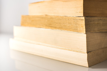Many stacked books with white background with space