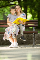 Mother and son sitting on a bench