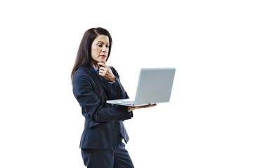Portrait of an interested woman in business suit standing and looking at laptop, isolated on white studio background 