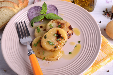 Sliced boiled potatoes and seasoned with vinegar oil and mint 