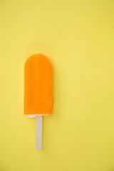 Popsicle with fresh orange on a table