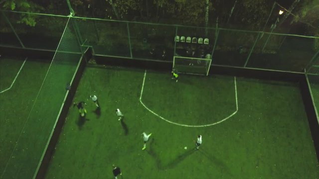 Aerial football match play. Clip. Aerial shot Two teams playing ball in football outdoors, top view. FIFA WORLD CUP 2018, Russia Football game outdoors, green field with markings, players running