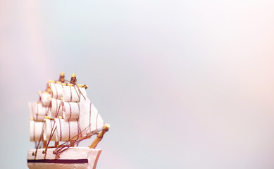 Old wooden ship with sails and masts toy on a stand. Vintage and