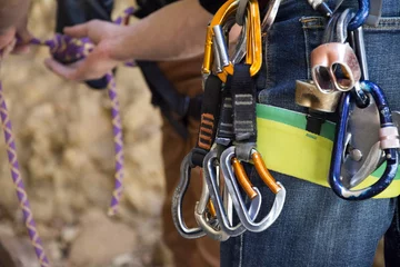 Velvet curtains Mountaineering carabiner hanging on a rock climber's harness