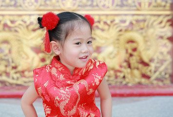 Little asian girl in cheongsam on traditional chinese new year festival.