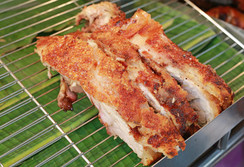 Piece of Golden whole roasted pig.