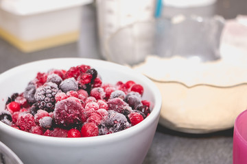 closeup of frozen red berries on a kitchen counter