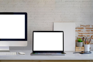 Mockup blank screen desktop and laptop computer on desk. workspace front view