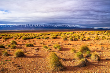 Amazing nature view of stone desert with mountains peaks and beautiful clouds. Location: Morocco, Africa. Artistic picture. Beauty world. The feeling of complete freedom