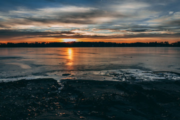 Sunrise over frozen lake