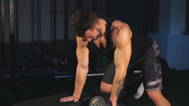 Handsome man doing exercise dumbbells in gym ,Strength and motivation Concept