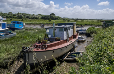 Naklejka na ściany i meble boats beached at low tide in dry estuary in braunton, devon, north, british, united, kingdom