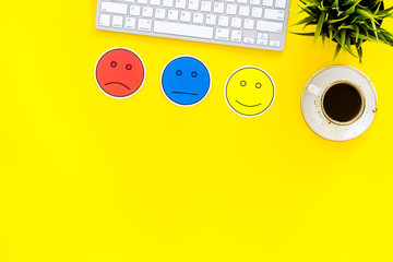 Customer satisfaction concept. Emoji smile, neutral, sad on work desk on yellow background top view copy space