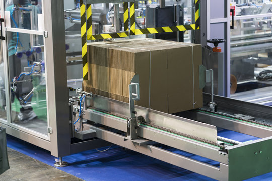 Automatic packing machine with plastic bag and paper box