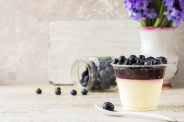 Italian dessert pana cota with berry jam and fresh blueberries