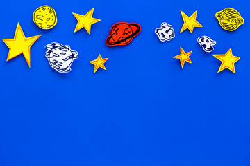 Space concept. Drawn stars, planets, asteroids on blue outer space background top view copy space