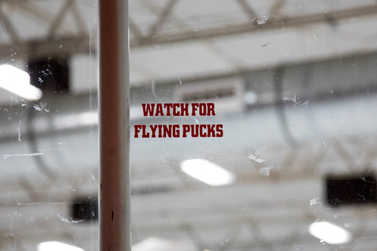 Warning to Watch for Flying Pucks at an ice hockey rink