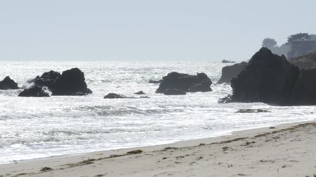 Waves splashing against rocks on the beach in California