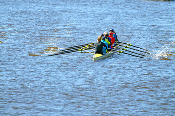 A team of rowers in a sports boat.