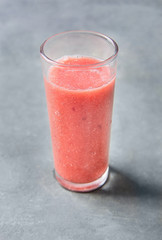 Glass with Fresh Strawberries Banana Smoothie. Dark Concrete Stone Background. Healthy Drink Detox Summer Refreshment Vitamins. Copy Space