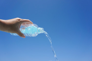Water flows from the plastic bottle. Image of hydration....