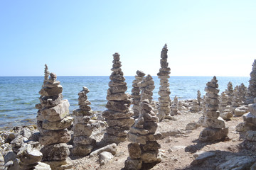 Inspiring stacked rock towers balancing on a zen beach
