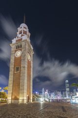 Fototapeta premium Old clock tower and skyline in Hong Kong city at night
