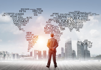 Motivation and inspiration concept with modern cityscape and businessman observing it