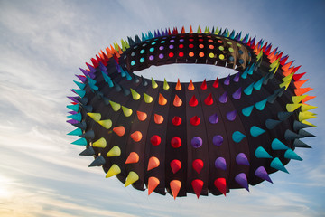 Giant, Ring-Shaped, Rainbow Spike Kite Flying in the Sky at Twilight