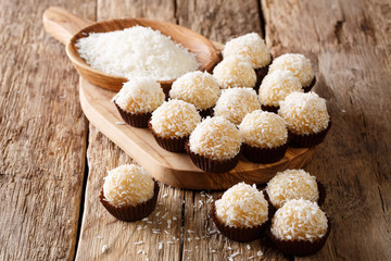 Authentic brazilian sweets beijinhos with condensed milk and coconut close-up. horizontal